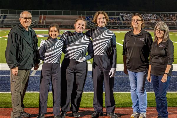 Summit High band members march